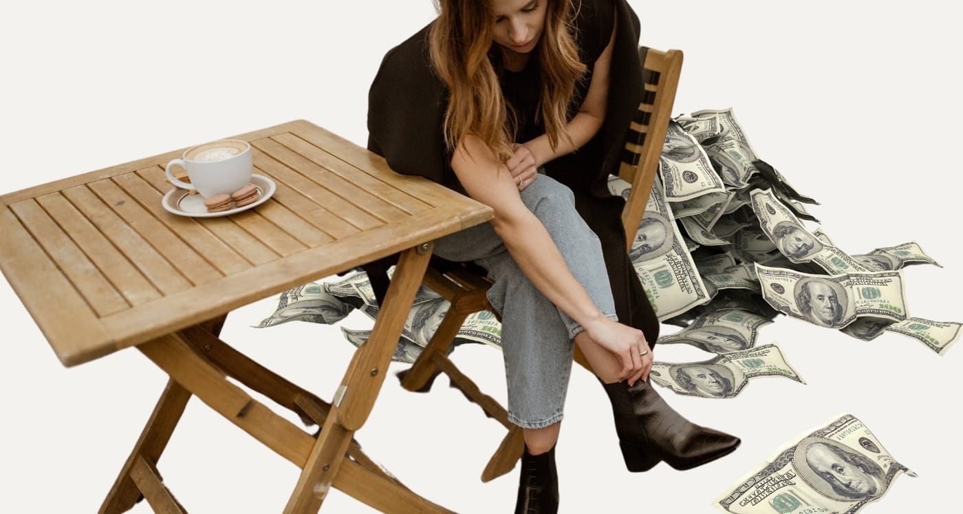 woman sitting at outdoor coffee table beside pile of money learning about hoe to set Intermediate Financial Goals