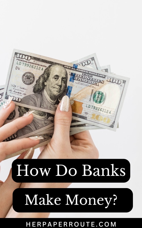 hand holding dollar bills showing how do banks make money