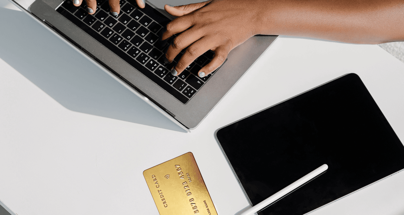 Hands on keyboard beside a credit card What To Do If You Impulse Purchase