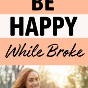 woman smiling in the sun and showing how to be happy when you're broke