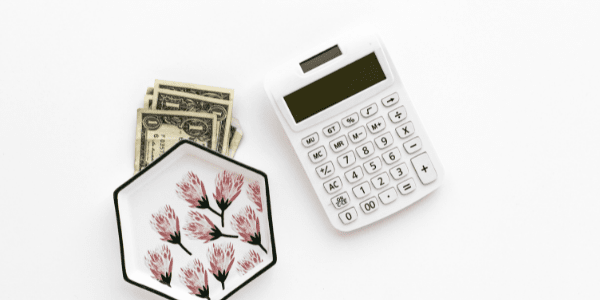 calculator on desk, adding up income from website flipping