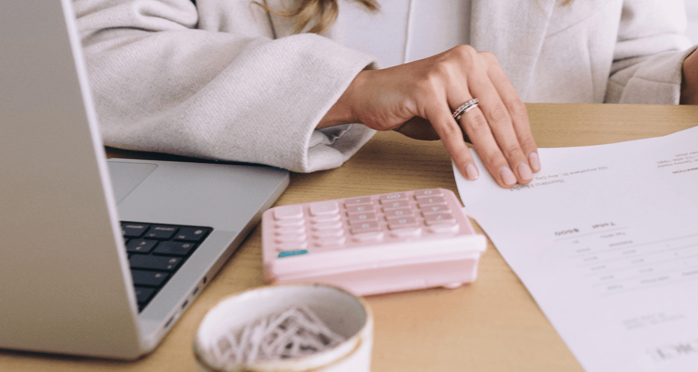 woman looking at budget papers considering Which Debt to Pay Off First to Improve Credit Score