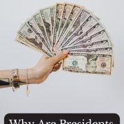 hand holding up a fan of cash answering the question why are presidents on money