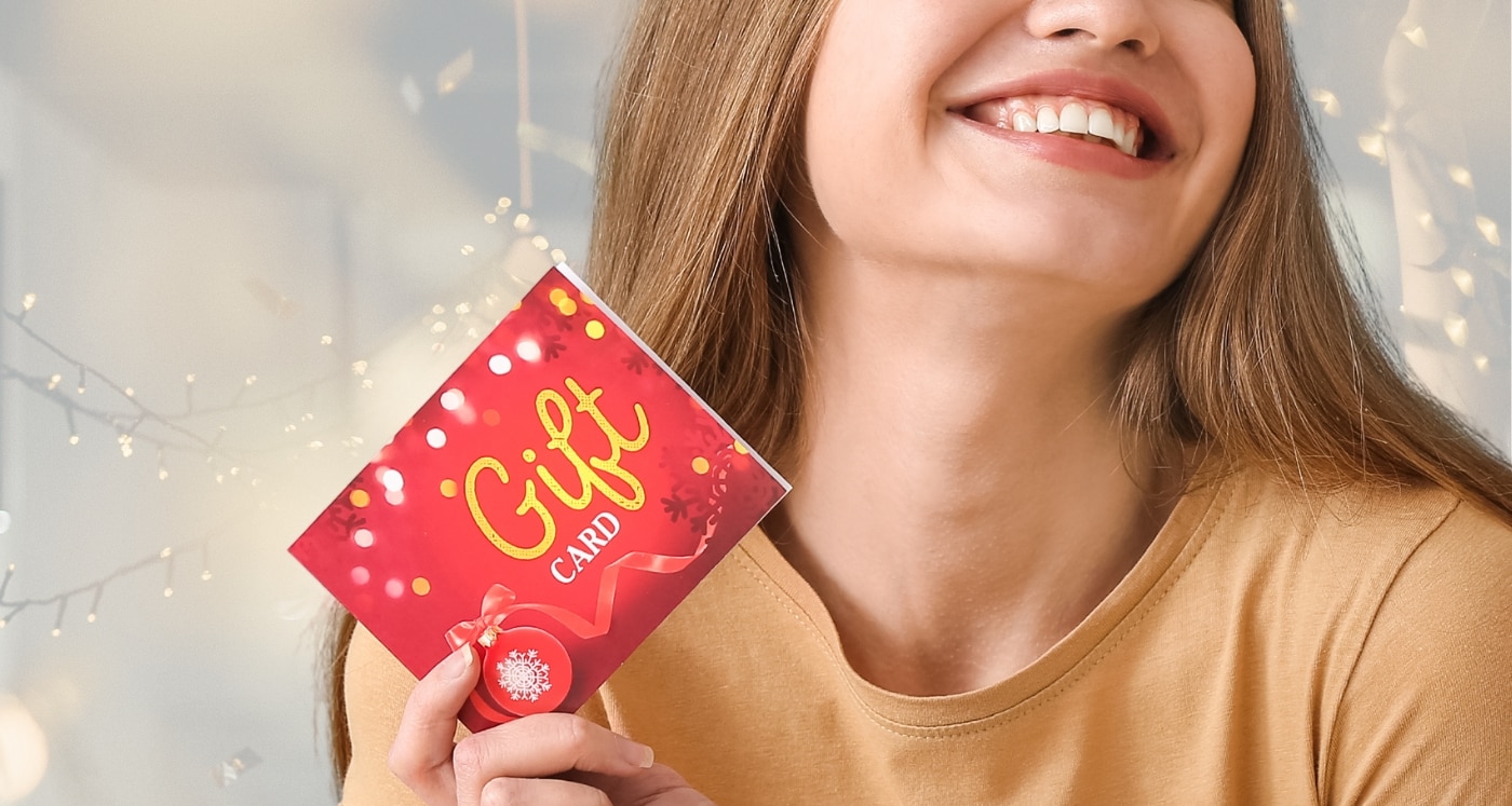 Christmas Happy Smiling Woman With Gift Box And Credit Card Stock