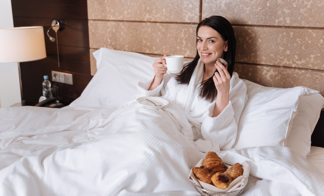 woman enjoying Fairmont Waterfront Gold suite, Vancouver