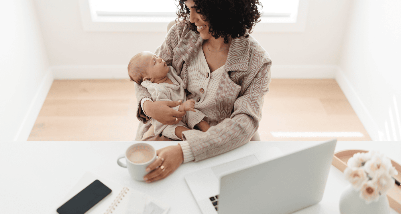 Mother holds baby and smiles as she learns How to Build Generational Wealth For Your Kids