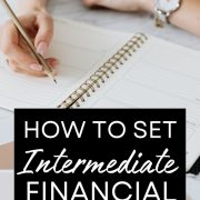 woman writing down her intermediate financial goals in a notebook