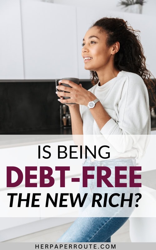 woman in her kitchen with a cup of coffee wondering is being debt free the new rich