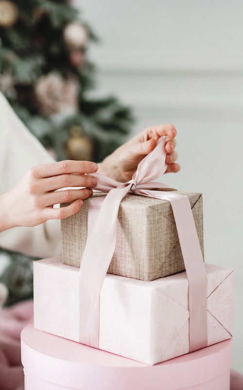 hands wrapping a gift - Gift wrapping service makes a great Winter side hustle