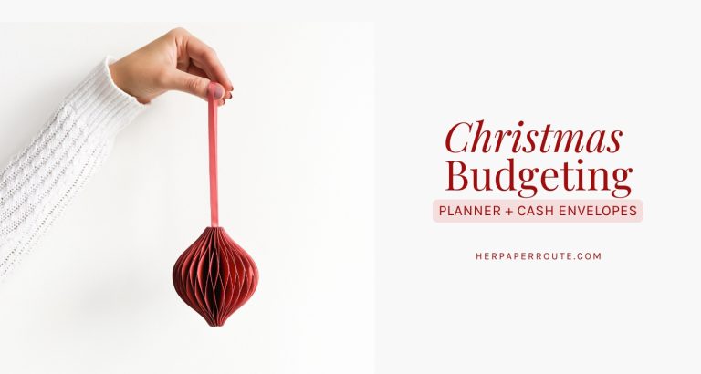 a hand holding a red ornament beside the words Christmas Budgeting Planner