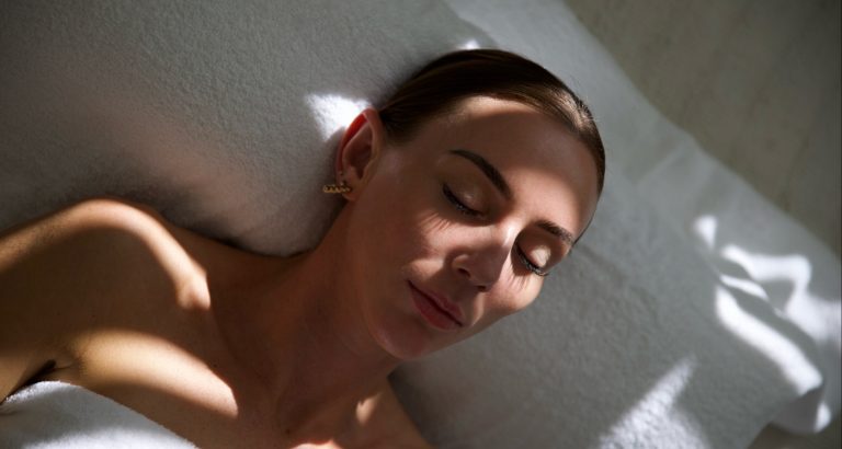 woman relaxing while listening to HerPaperRoute podcast episode about Identity-Based Habits: The Psychology Behind Your Glow-Up
