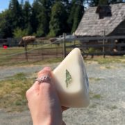 Planning the Perfect Day in South Cowichan, Itinerary 2 holding up some cheese from cowichan station creamery